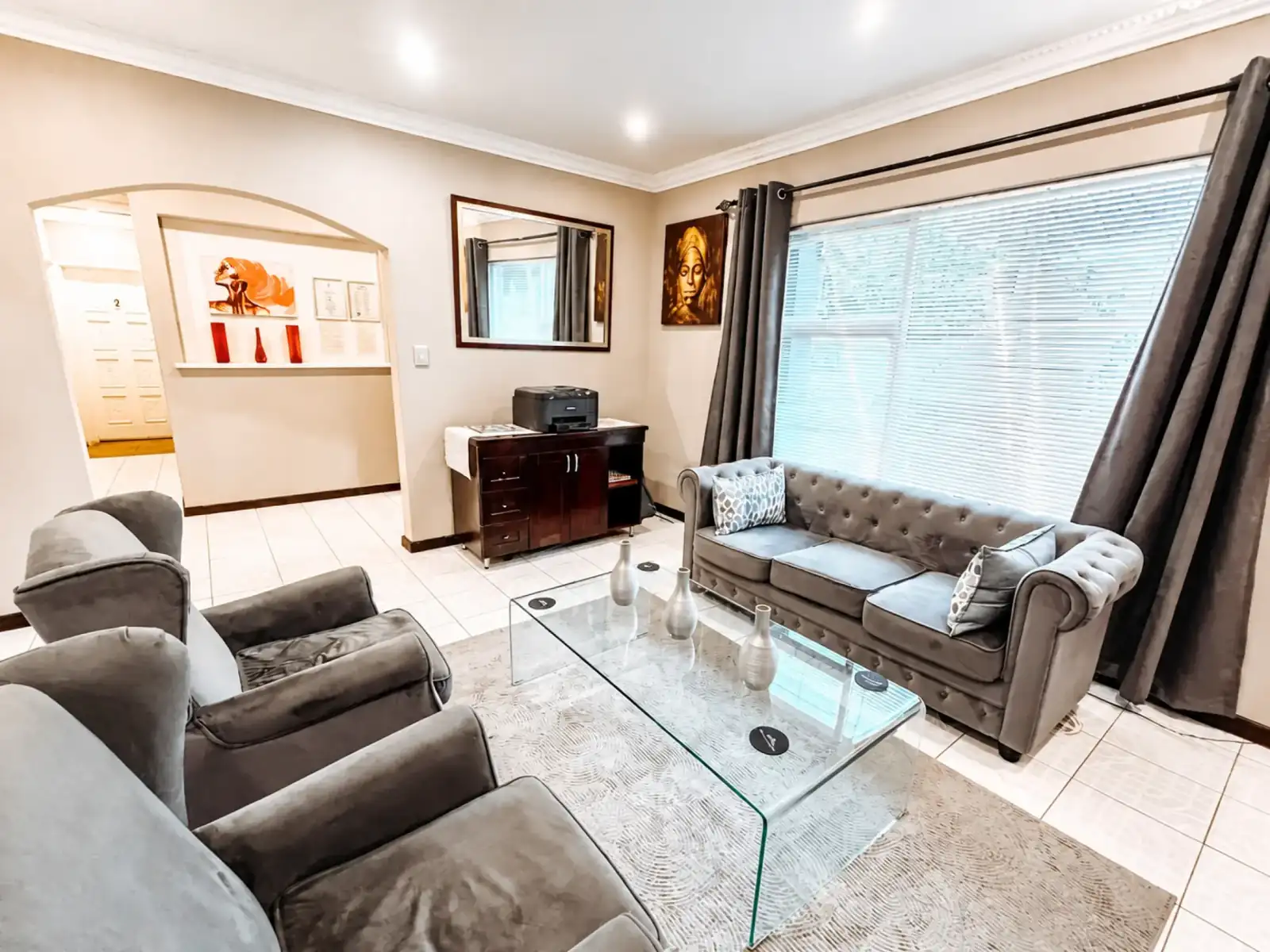 Comfortable guest lounge with seating and a glass coffee table